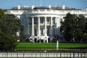 Front view of the iconic White House in Washington, DC, showing its lawn and fountain.